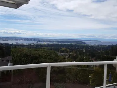 a view of the water from the balcony of a house at Emperial Suites in North Vancouver