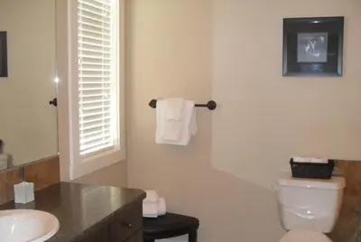 a bathroom with a white toilet and a sink at Mountain View Radium Condo - Copper Horn Village in Radium Hot Springs