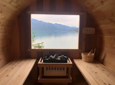 a window in a sauna with a view of a lake at The Lodge on Harrison Lake in Harrison Hot Springs