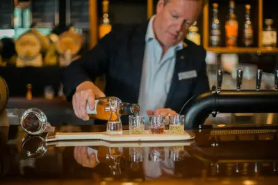 a bartender making cocktails at a bar at Hotel Eldorado at Eldorado Resort in Kelowna