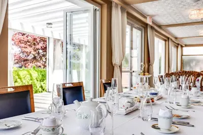 a dining room with a long white table with glasses at Hotel Eldorado at Eldorado Resort in Kelowna