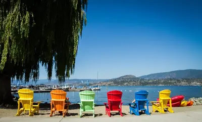 a group of colorful chairs sitting on the beach at Hotel Eldorado at Eldorado Resort in Kelowna