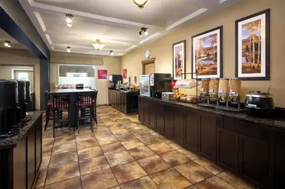 a restaurant with a bar with a table and chairs at Best Western Plus Kamloops Hotel in Kamloops