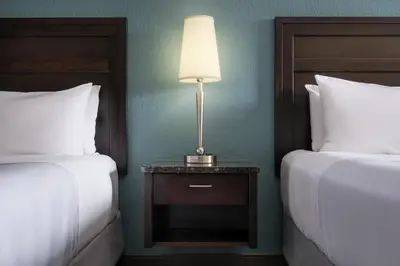 a hotel room with two beds and a table with a lamp at Best Western Plus Kamloops Hotel in Kamloops