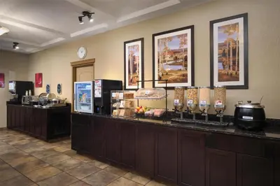 a restaurant with a counter with food on it at Best Western Plus Kamloops Hotel in Kamloops