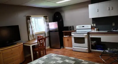 a kitchen with a stove and a refrigerator and a table at Overlook Inn & Cabins in Clearwater