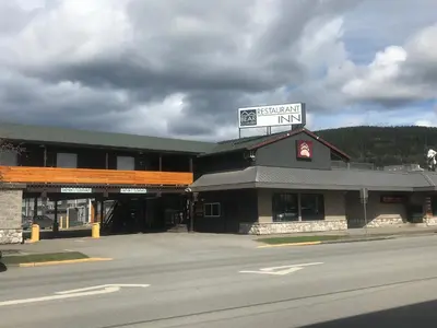 a building with a sign on top of it on a street at Bear Country Inn in Terrace