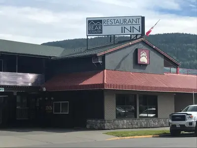 a restaurant with a sign on top of a building at Bear Country Inn in Terrace