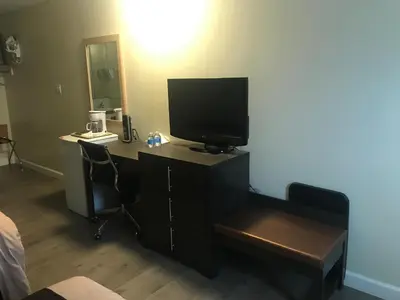 a room with a desk with a television on it at Bear Country Inn in Terrace