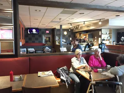 two older women sitting at a table in a restaurant at Bear Country Inn in Terrace