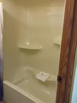 a white bath tub with a white towel in it at The Ranchland Inn Kamloops in Kamloops