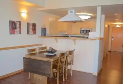a kitchen and dining room with a table and chairs at Sunset Resorts Canmore and Spa in Canmore