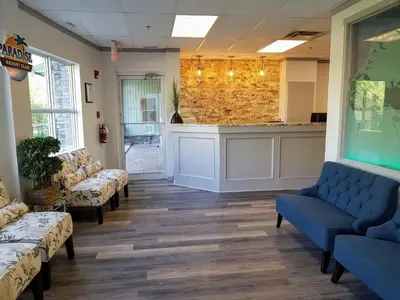 a waiting room with blue couches and a counter at Sunset Mountain Inn in Canmore