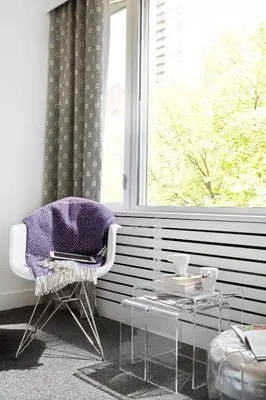 a living room with a chair and a window at The Burrard in Vancouver