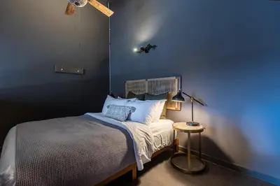 a bedroom with a bed with a blue wall at Creekside Villa in Canmore