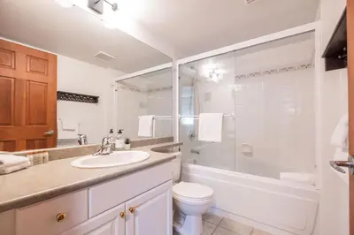 a bathroom with a sink and a toilet and a shower at Lagoons by Outpost Whistler in Whistler