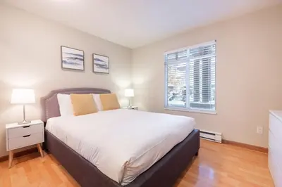 a bedroom with a large bed and a window at Lagoons by Outpost Whistler in Whistler