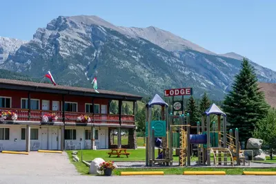 a hotel with a playground in front of a building at Rocky Mountain Ski Lodge in Canmore