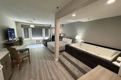 a hotel room with a bed and a bath tub at Western Budget Motel Leduc #3 in Leduc