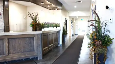 a lobby of a building with potted plants at Western Budget Motel Leduc #3 in Leduc
