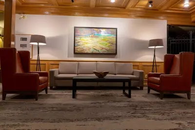 a living room with a couch and two chairs at Whistler's Inn in Jasper