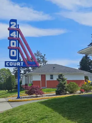 a sign for a hotel with a hotel room at 2400 Motel in Vancouver