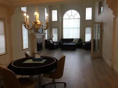 a large living room with a table and chairs at Go House in Richmond