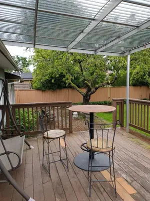a patio with a table and two chairs and a table at Semi Centre House in White Rock