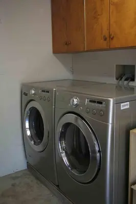 a stainless steel washer and dryer in a kitchen at Semi Centre House in White Rock