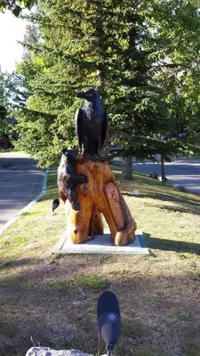 a statue of a bird sitting on top of a fire hydrant at Douglas Fir Resort & Chalets in Banff