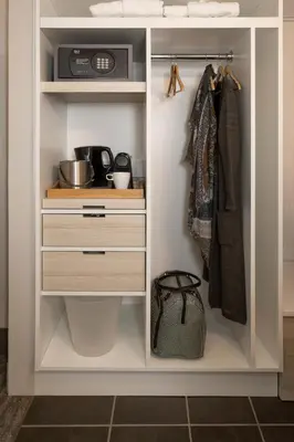 a white closet with drawers and a microwave at Banff Aspen Lodge in Banff