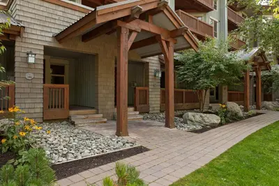 a home with a wooden pergola and a walkway at Horstman House by Whistler Premier in Whistler