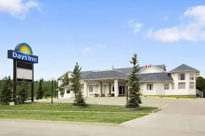 a day inn sign in front of a house at Days Inn by Wyndham Hinton in Hinton