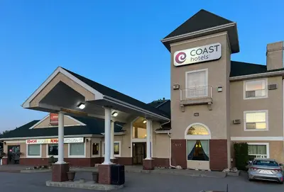 a coast hotel with a car parked in front of it at Coast Hinton Hotel in Hinton