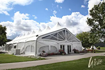 a large white tent in a field of grass at St. Eugene Golf Resort & Casino in Cranbrook