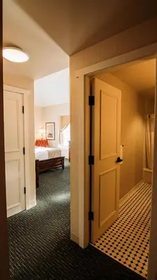 a room with a door leading to a bedroom at St. Eugene Golf Resort & Casino in Cranbrook