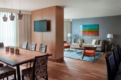 a living room with a dining table and a couch at Vancouver Marriott Pinnacle Downtown Hotel in Vancouver