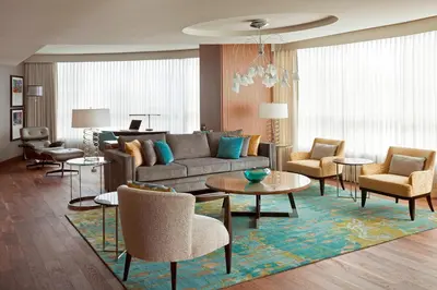 a living room with a couch and tables and chairs at Vancouver Marriott Pinnacle Downtown Hotel in Vancouver