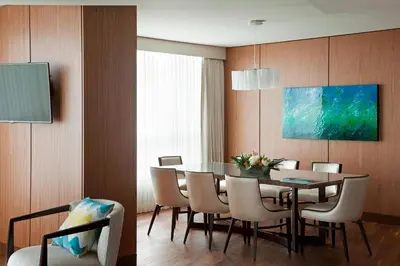a dining room with a table and chairs at Vancouver Marriott Pinnacle Downtown Hotel in Vancouver