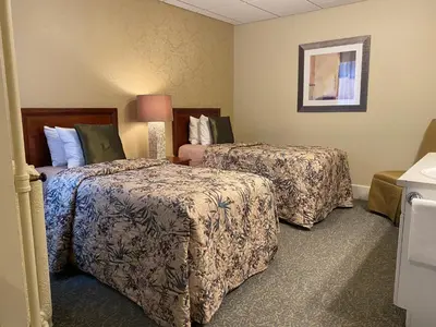 a hotel room with two beds in a room at Kingston Hotel in Vancouver