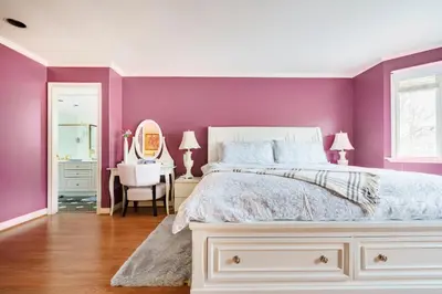a bedroom with purple walls and a white bed at Fraser River Richmond Bed and Breakfast in Richmond