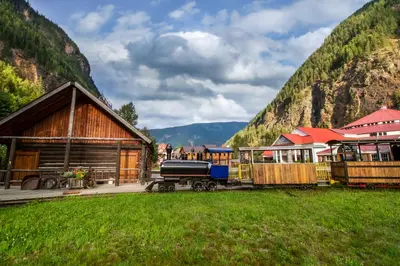 a train yard with a train station and a building at Three Valley Lake Chateau in Revelstoke