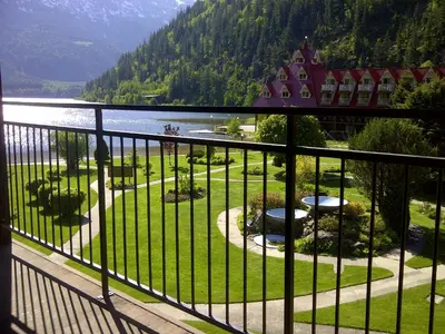 a balcony with a view of a resort and a lake at Three Valley Lake Chateau in Revelstoke