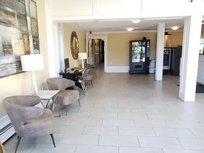 a lobby with chairs and tables in a building at Arbutus Inn in Victoria