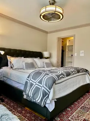 a bedroom with a large bed with a black headboard at Jessicahouse ltd. in Richmond