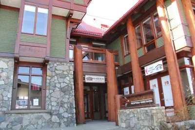 a large building with wooden columns and windows at Great Condo In Excellent Location - Waterfront Building - Seaside in Ucluelet
