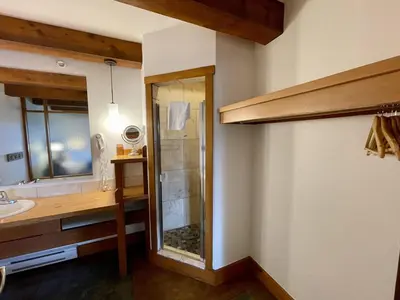 a bathroom with a shower and a sink and a mirror at Great Condo In Excellent Location - Waterfront Building - Seaside in Ucluelet