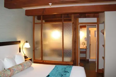 a bedroom with a bed with a glass wall at Beautiful Condo In A Great Location, Oceanfront Complex - Oe in Ucluelet