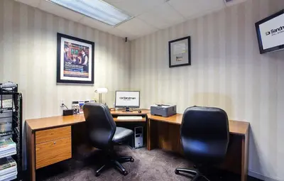 an office with two chairs and a desk with a computer at Sandman Hotel Victoria in Victoria