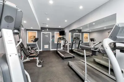 a gym with treadmills and elliptical machines at Sandman Hotel Grande Prairie in Grande Prairie